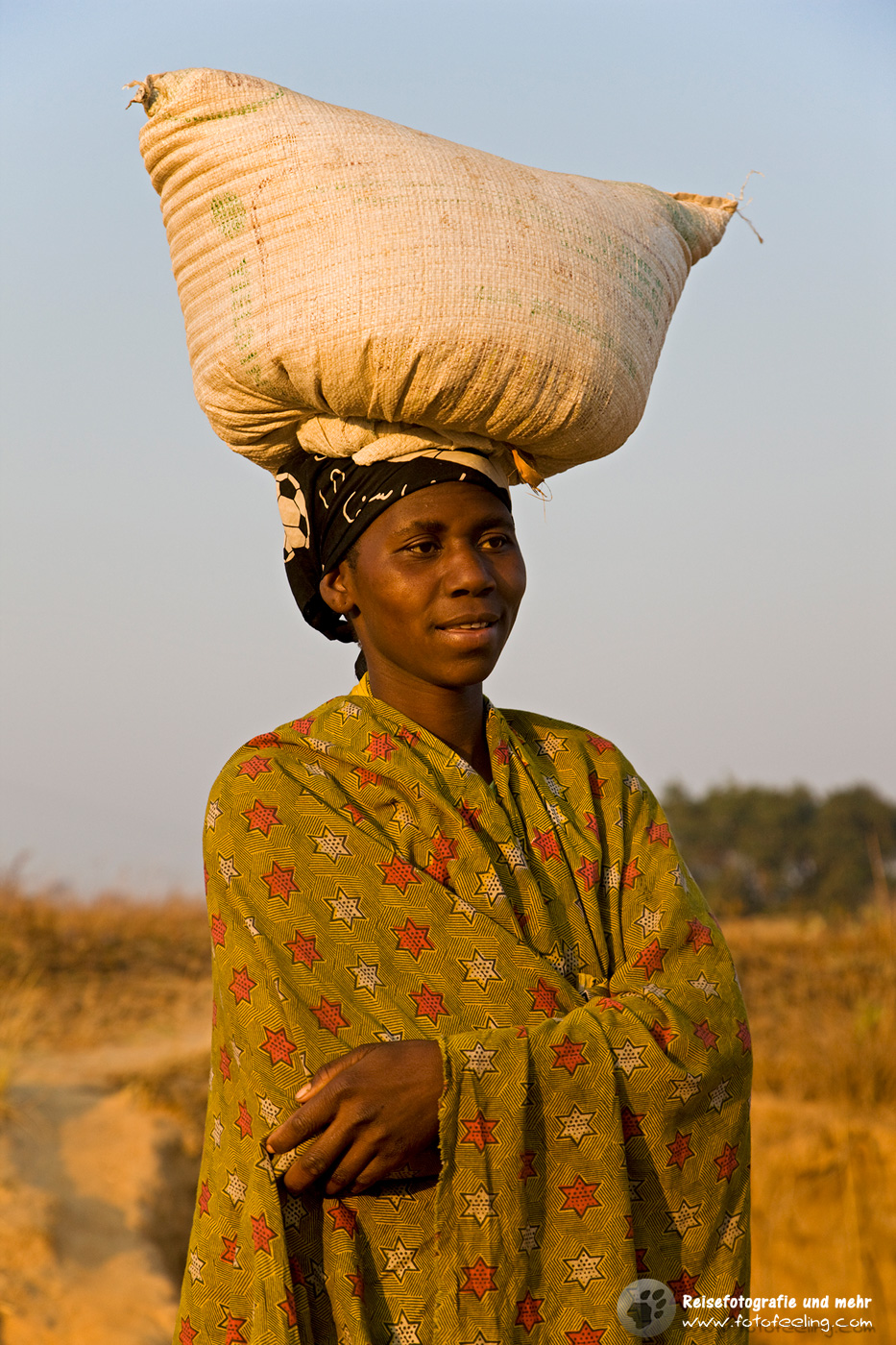 Frau mit Last auf dem Kopf