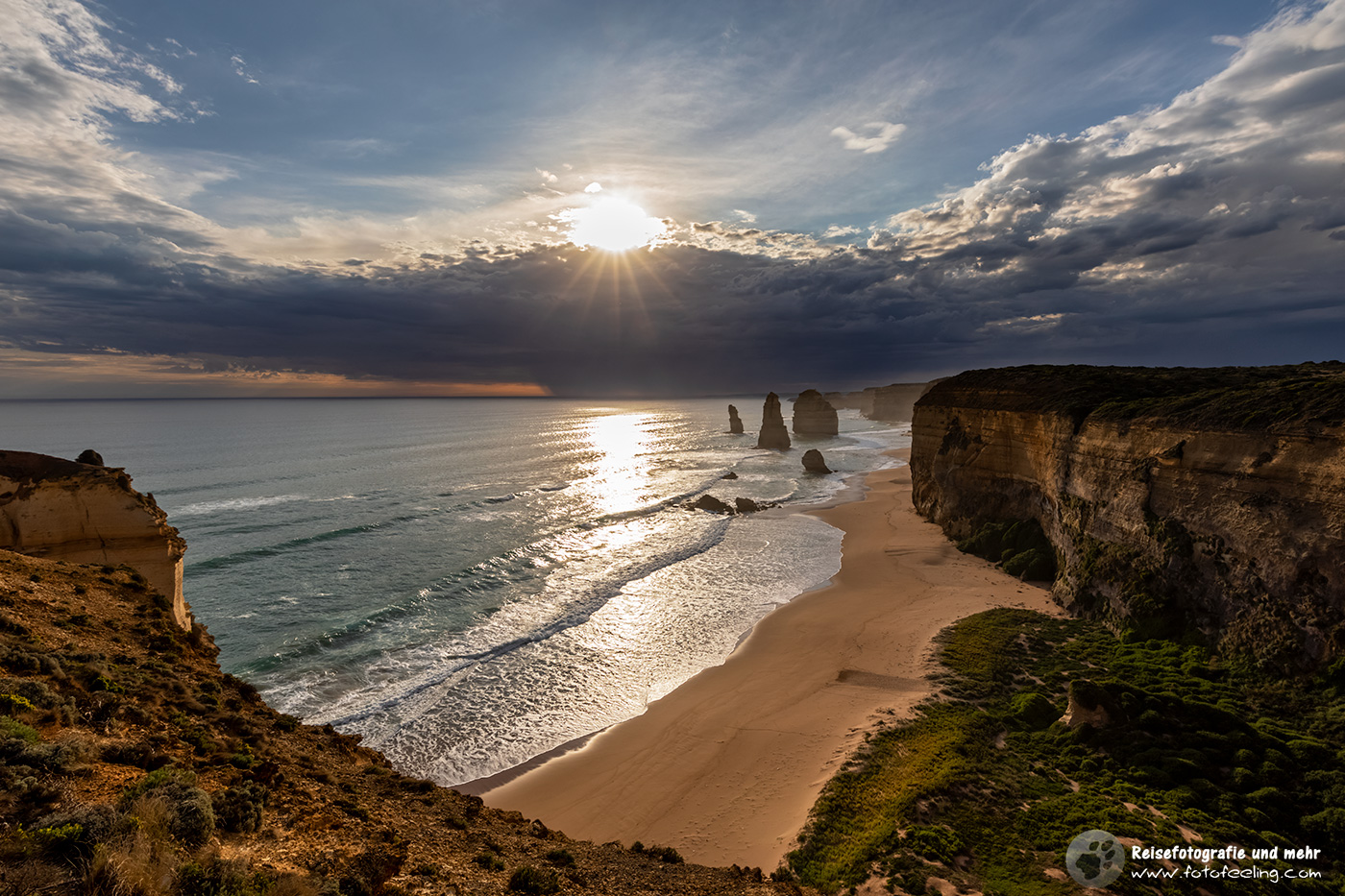 Die Sonne versinkt in einer Wolkenfront, Zwölf Apostel (Twelve Apostles), Great Ocean Road, Victoria, Australien